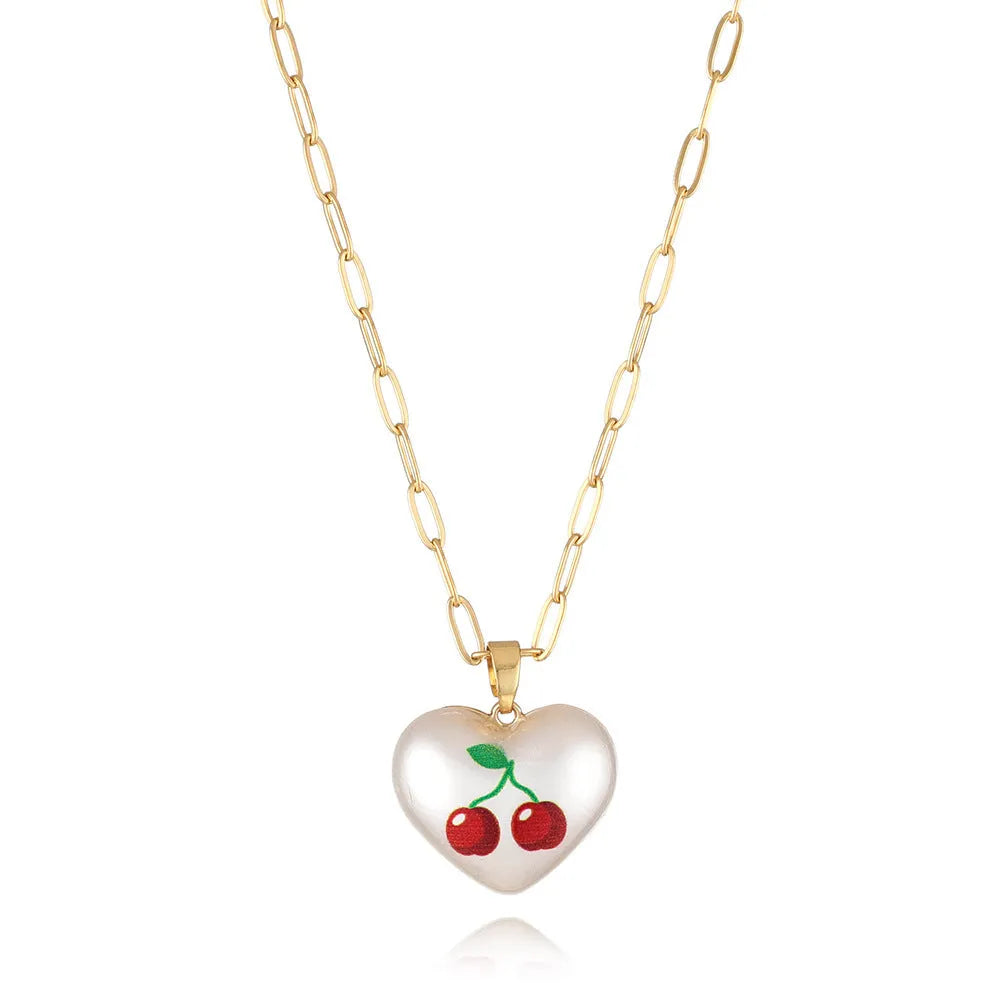 Geometric heart-shaped necklace with a choice of strawberry, pineapple, apple, pear or cherry pendant on an adjustable chain.