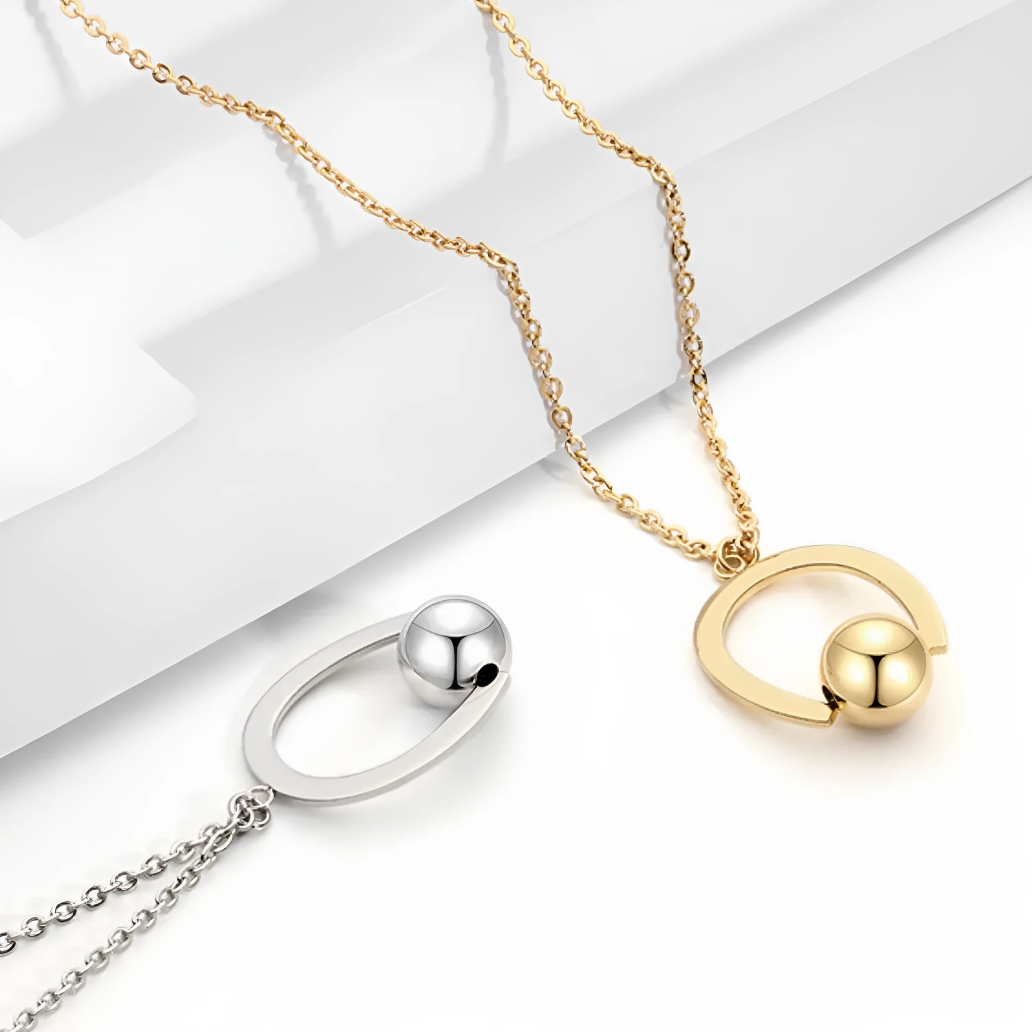 Stainless steel geometric pendant necklace on a cross chain, shown in gold colour.