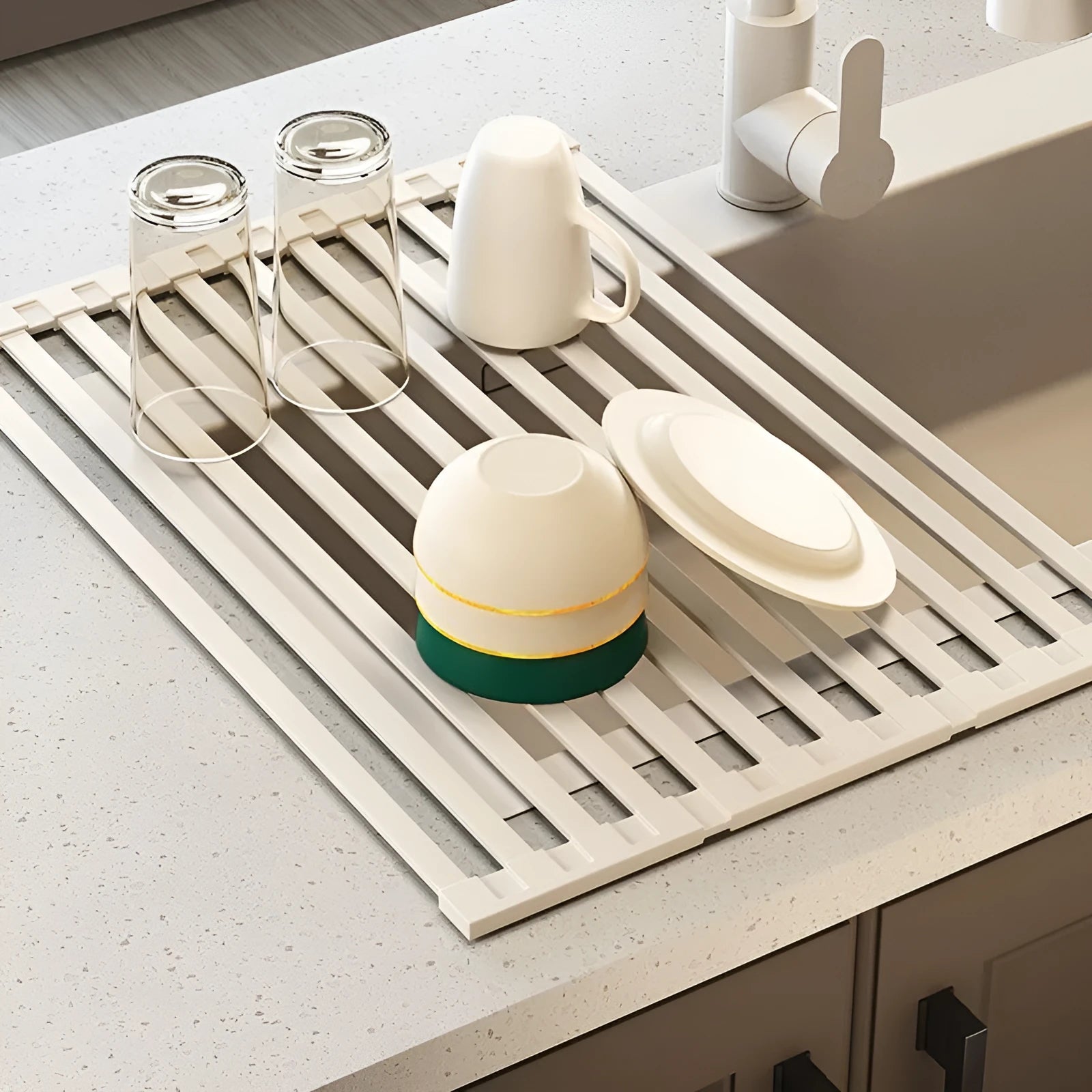 Foldable milky white stainless steel kitchen draining rack beside a sink