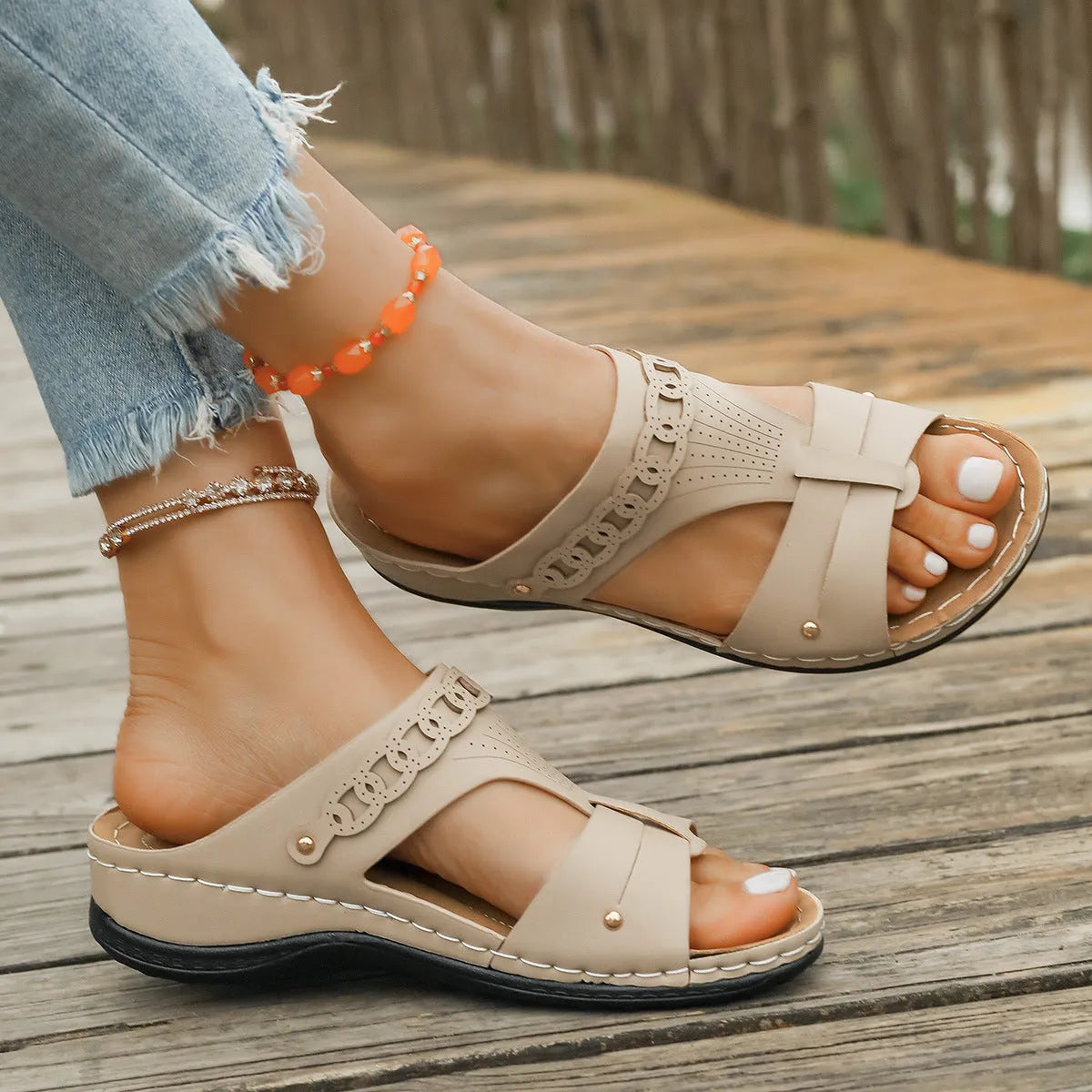 Roman style slope heel slippers with fish mouth toe in multiple colours on a rubber sole.