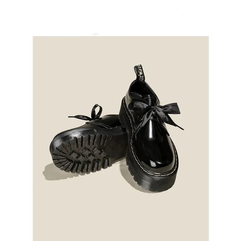 Women's black thick-soled lace-up shoes with white ribbon cross strap details on a superfine fibre upper.