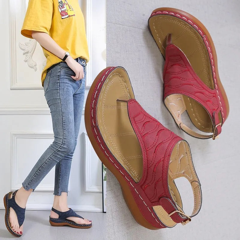Women's casual wedge heel flip flop sandals with an adjustable buckle strap in solid colours.