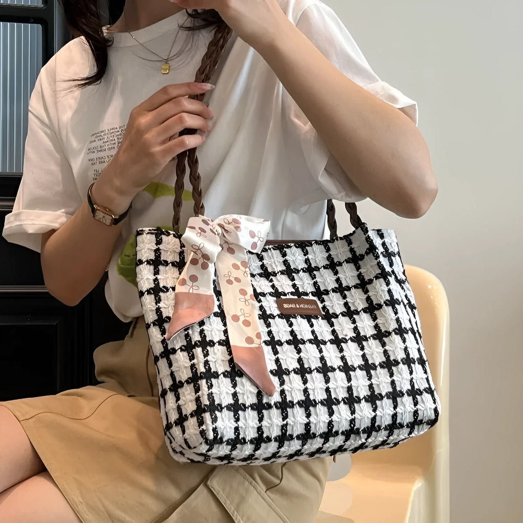 Black wool shoulder bag with horizontal square shape showing interior file compartment and phone pocket