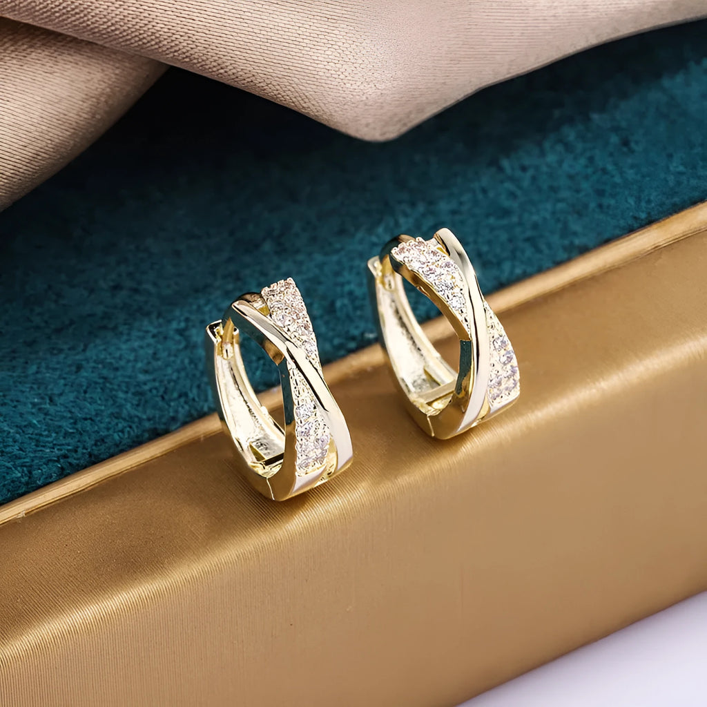 A pair of geometric drop earrings with zircon crystals in a 14K yellow finish.