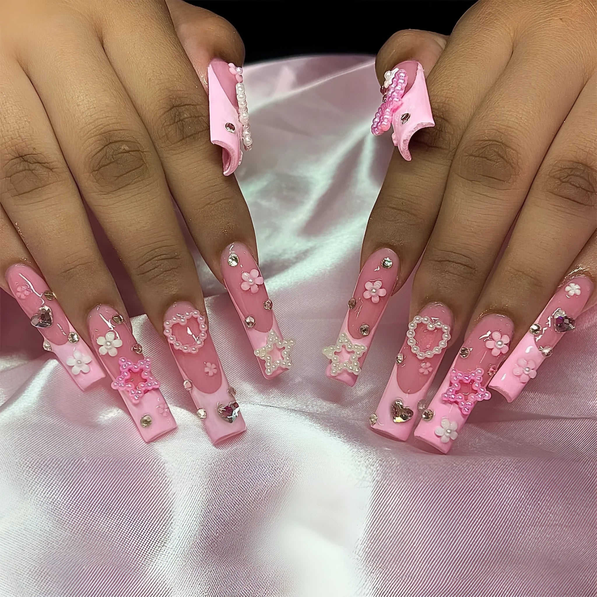 Super long water pipe shaped false nails with French spot and drill bow design in XB-70-48 pink.