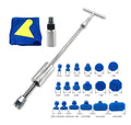Automotive dent repair tool kit showing a metal T-shaped hammer and blue adhesive pads on a car panel.