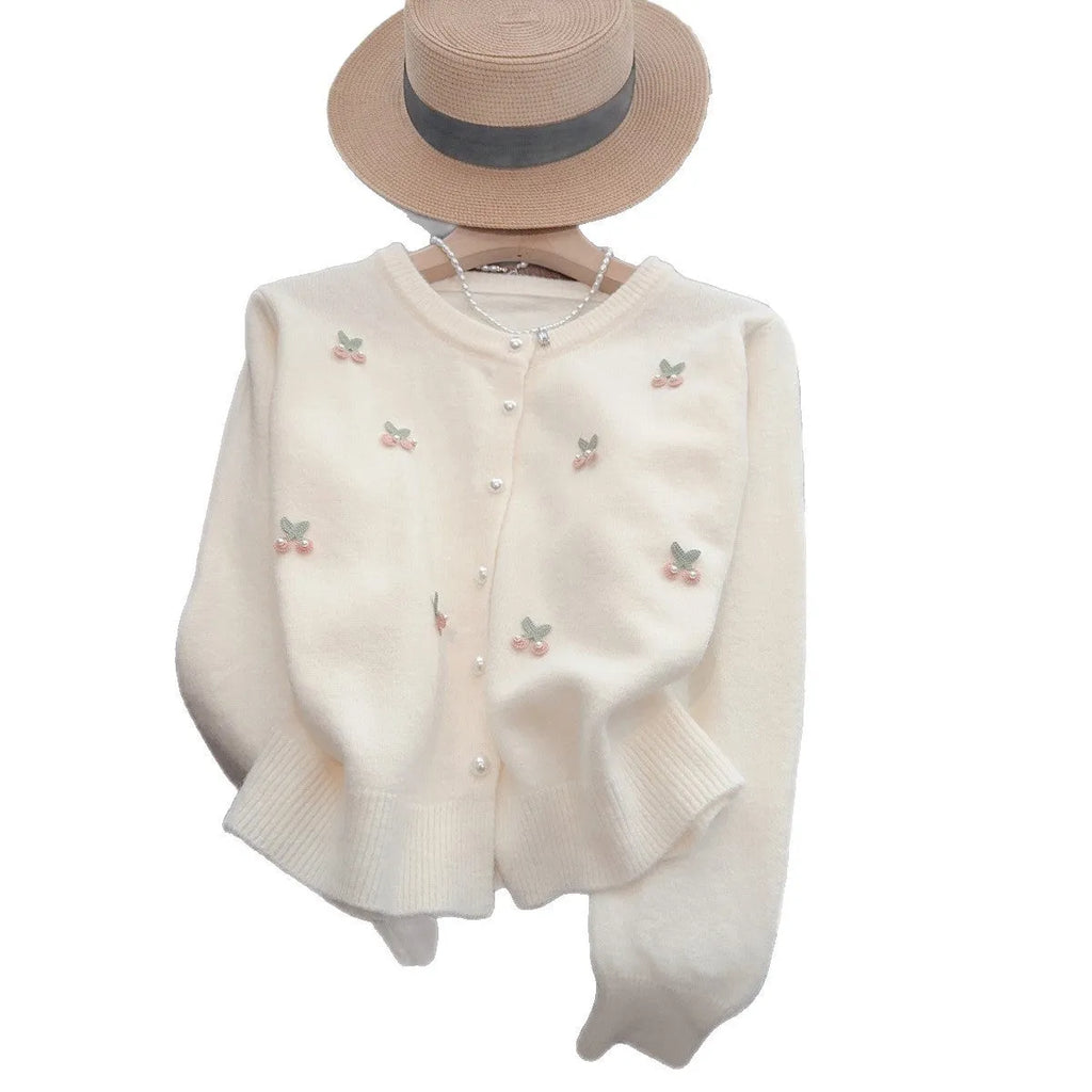 Pink cashmere blend cardigan coat with beaded details on a hanger