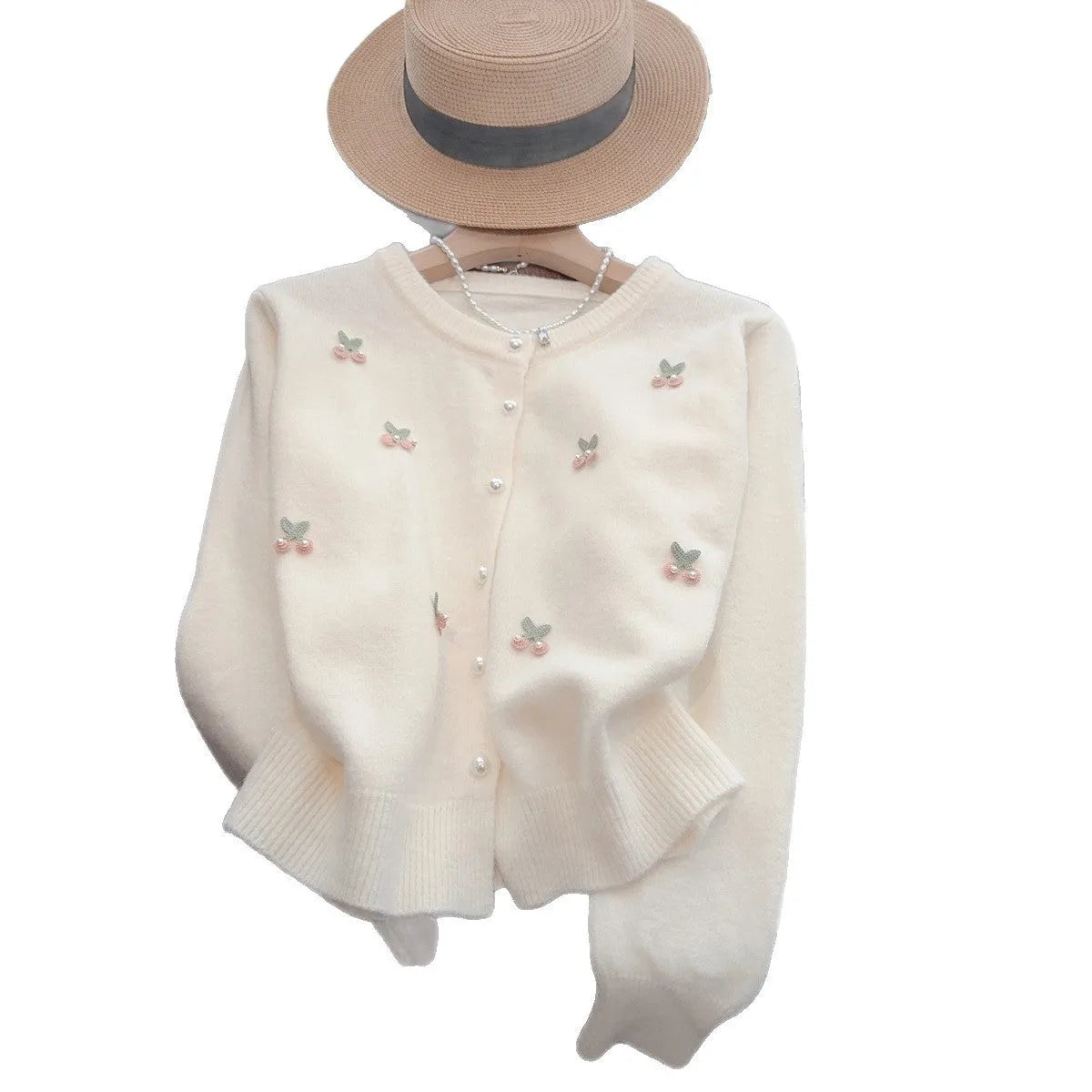 Pink cashmere blend cardigan coat with beaded details on a hanger