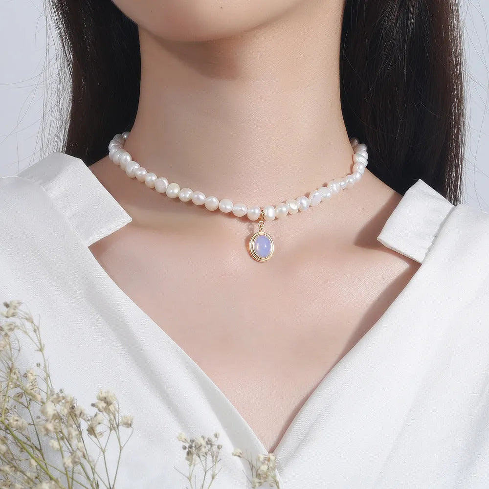 Silver geometric necklace with round medal and pearl pendant on adjustable chain