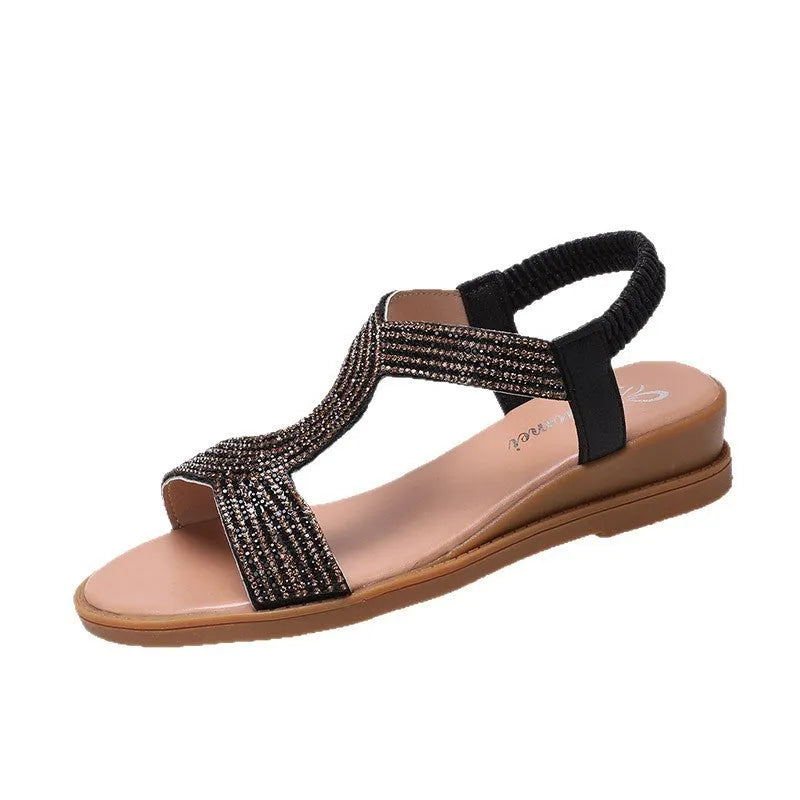 Women's gold PU leather beach sandals with rhinestone decoration on the strap.