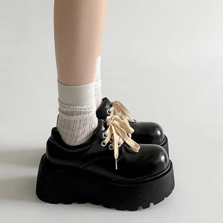 Matte black women's lace-up ankle boots with a chunky 6-8 cm heel and thick rubber sole.