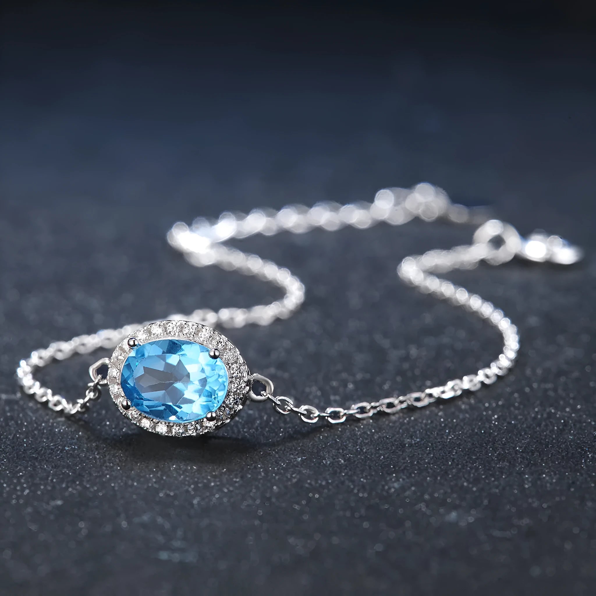 925 sterling silver geometric jewellery set with blue topaz gemstones including earrings, ring, pendant and necklace
