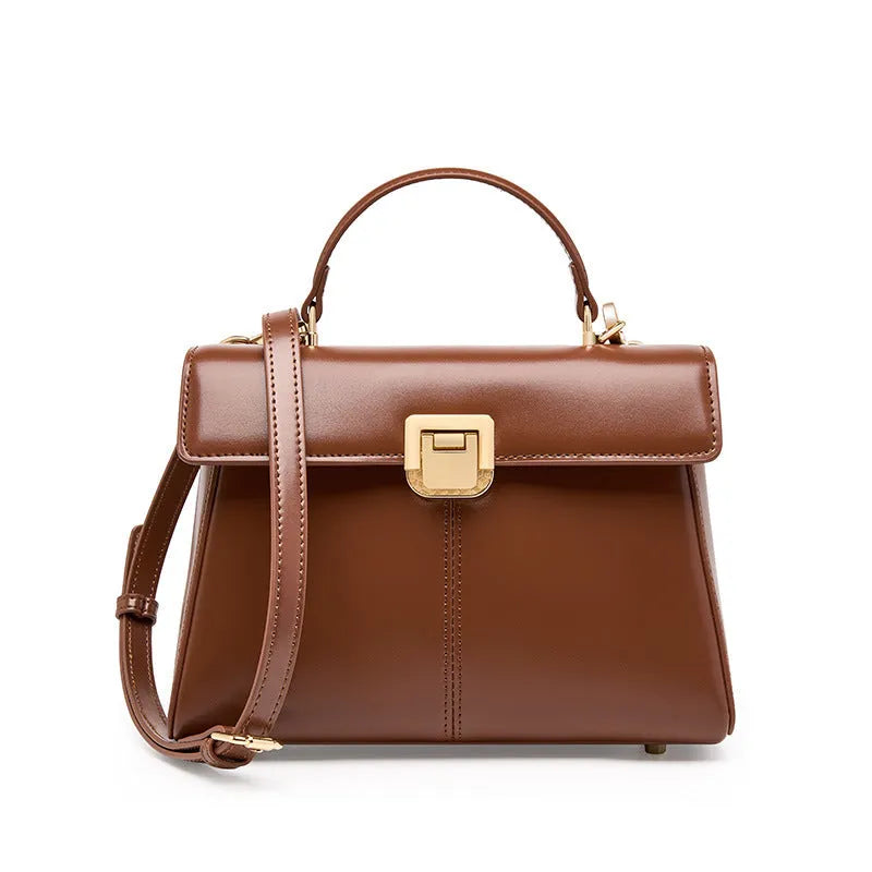 Women's black leather shoulder bag with vachette clasp showing horizontal square shape and shoulder strap