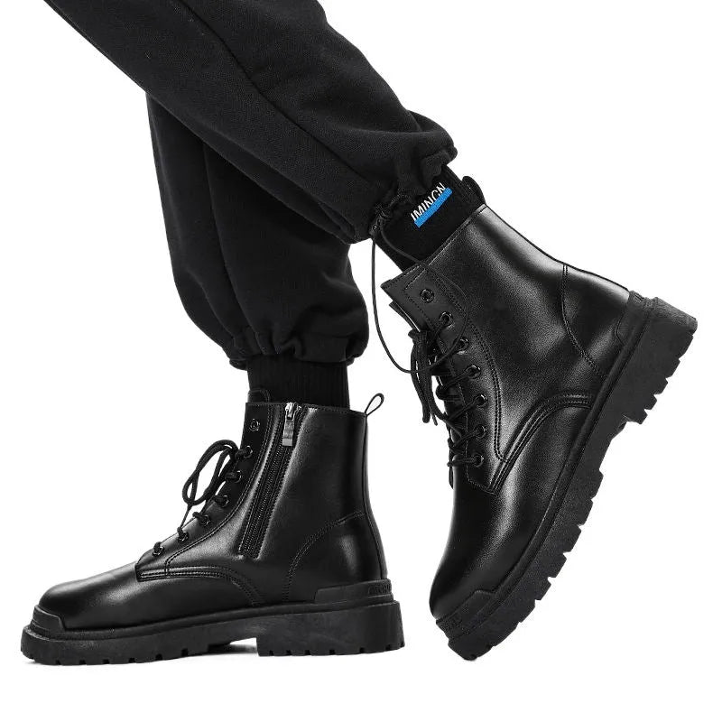Men's black mid-top leather work boots with a flat rubber sole, shown from the side.