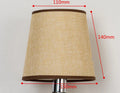 Modern minimalist white fabric lampshade on a wooden table next to other colour options.