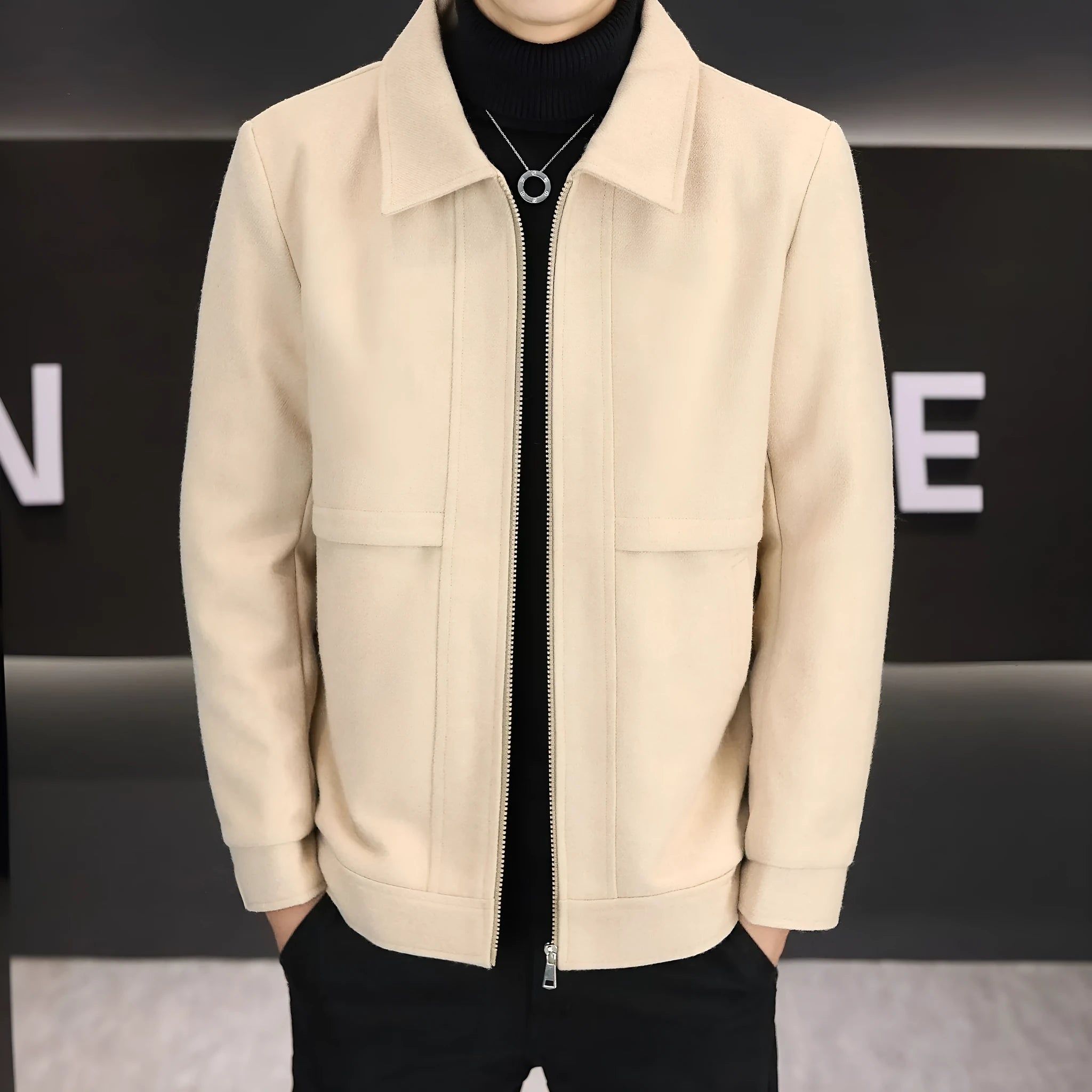 Man wearing a khaki polo collar casual jacket with side seam pockets.