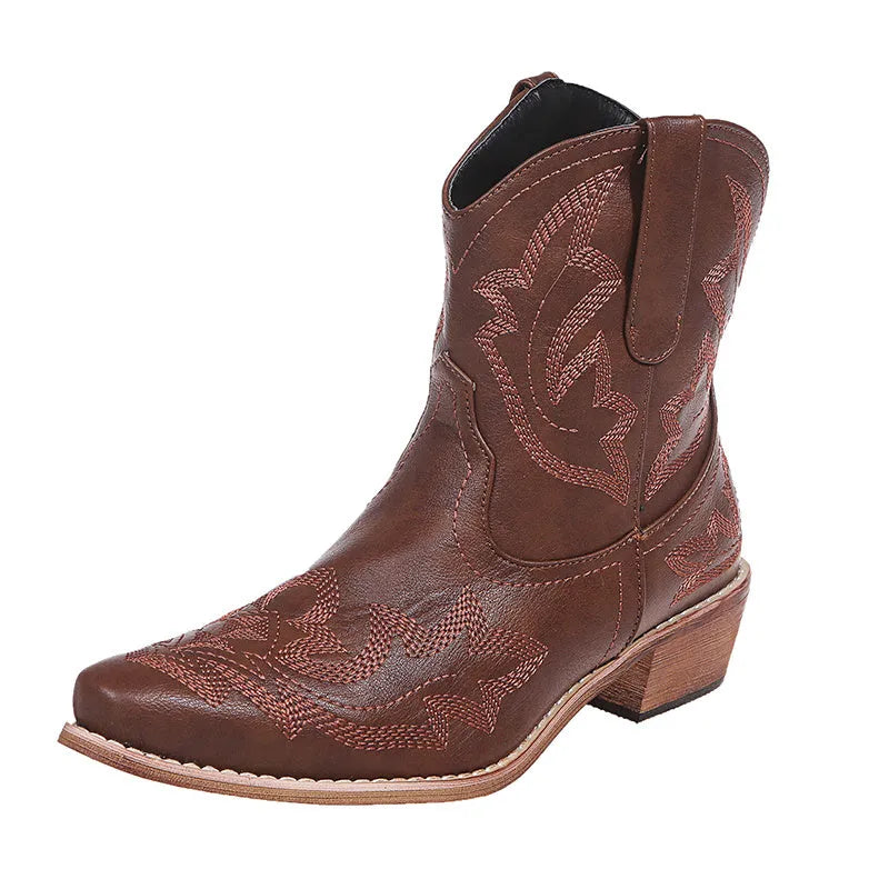 Women's blue cowboy boot with embroidery detail on the side, low wedge heel, and pointed toe.