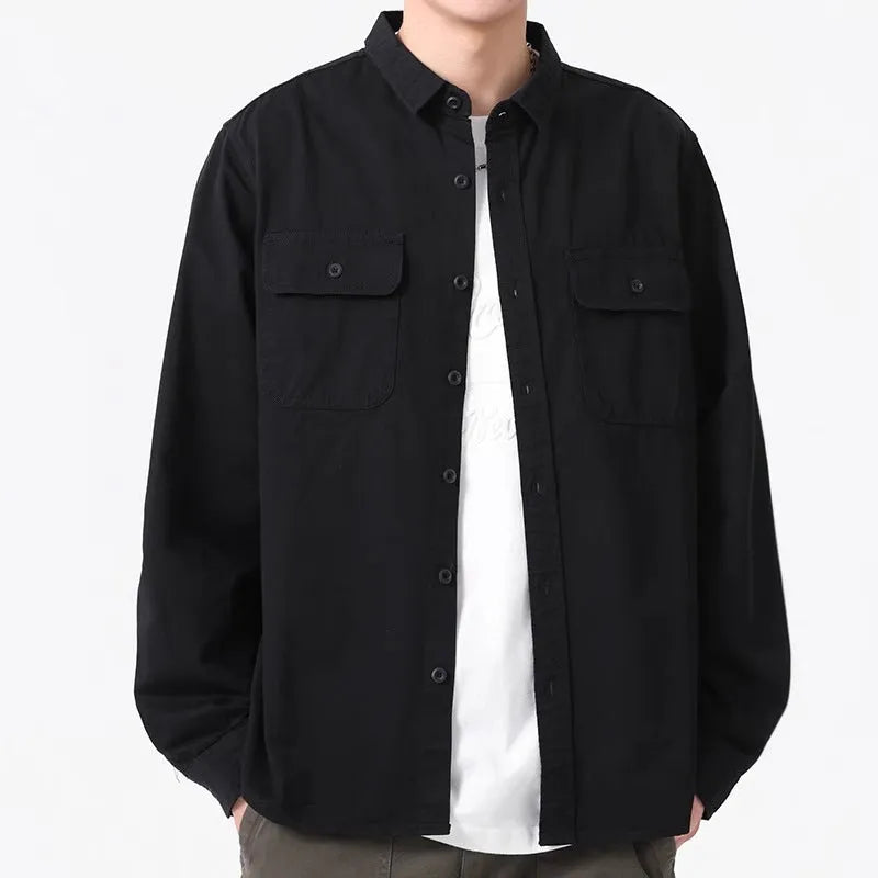 Man wearing a loose-fit grey long sleeve cardigan-style shirt, showcasing its relaxed silhouette and polyester material.