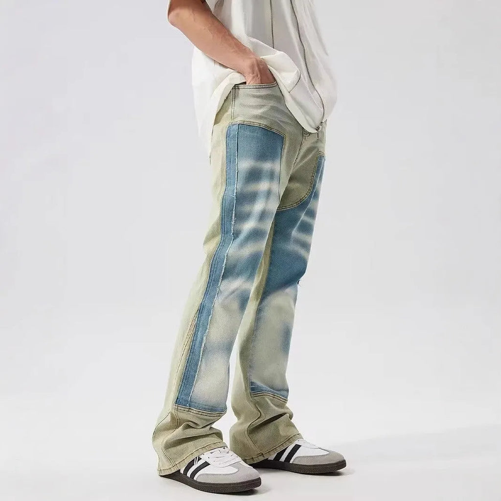 Retro yellow and blue dual-colour patchwork splash-ink damaged design jeans with mid waist and zip fly.
