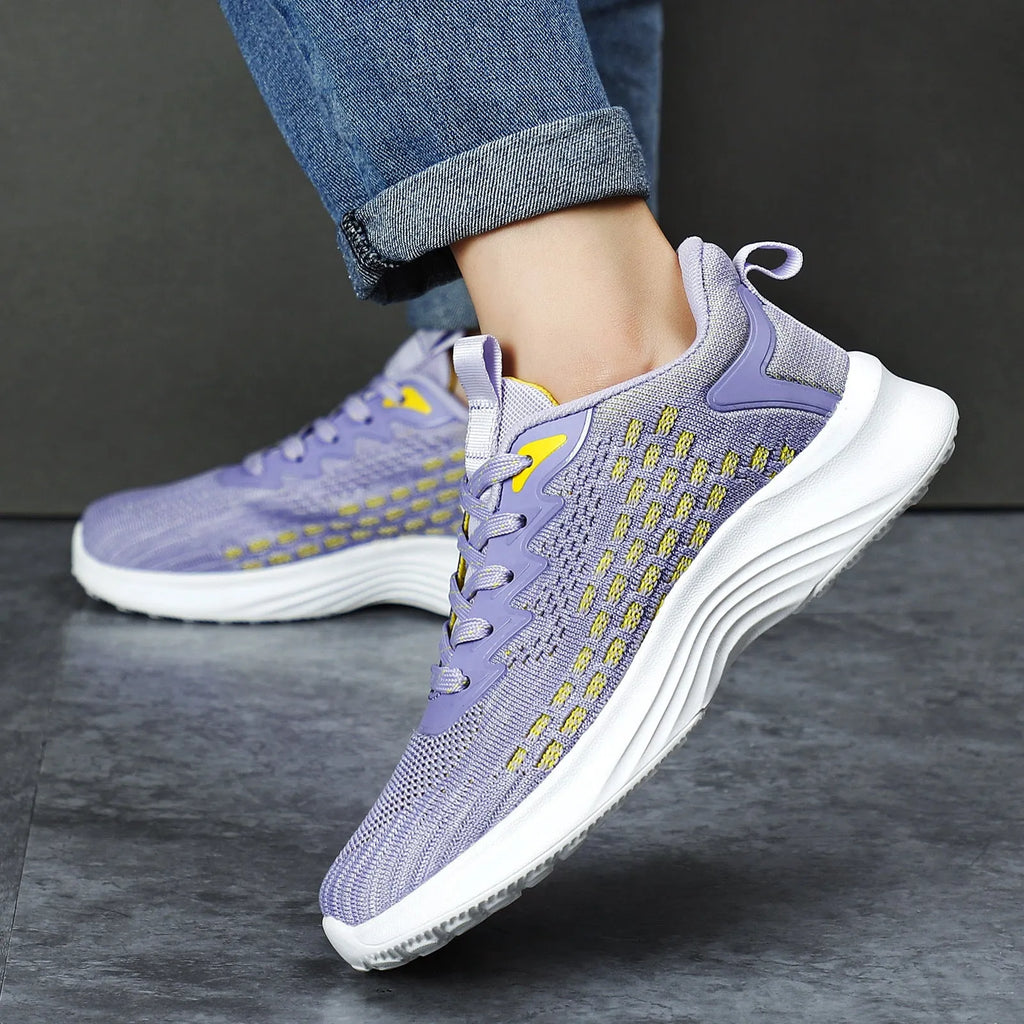 Women's lavender purple Flyknit running shoes with striped pattern and mesh upper on a white background.