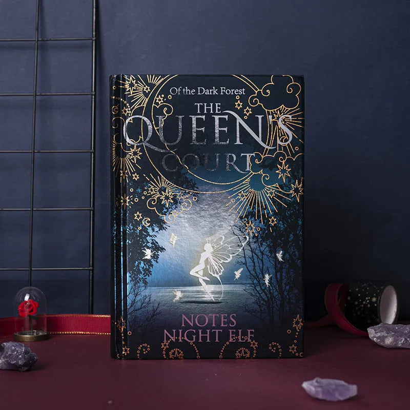 Blue A5 hardcover luminous notebook with retro night elves illustrations open to show full-colour interior pages