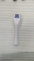 Sterile 540 micro needle derma roller showing handle and needle wheel in assorted colours.