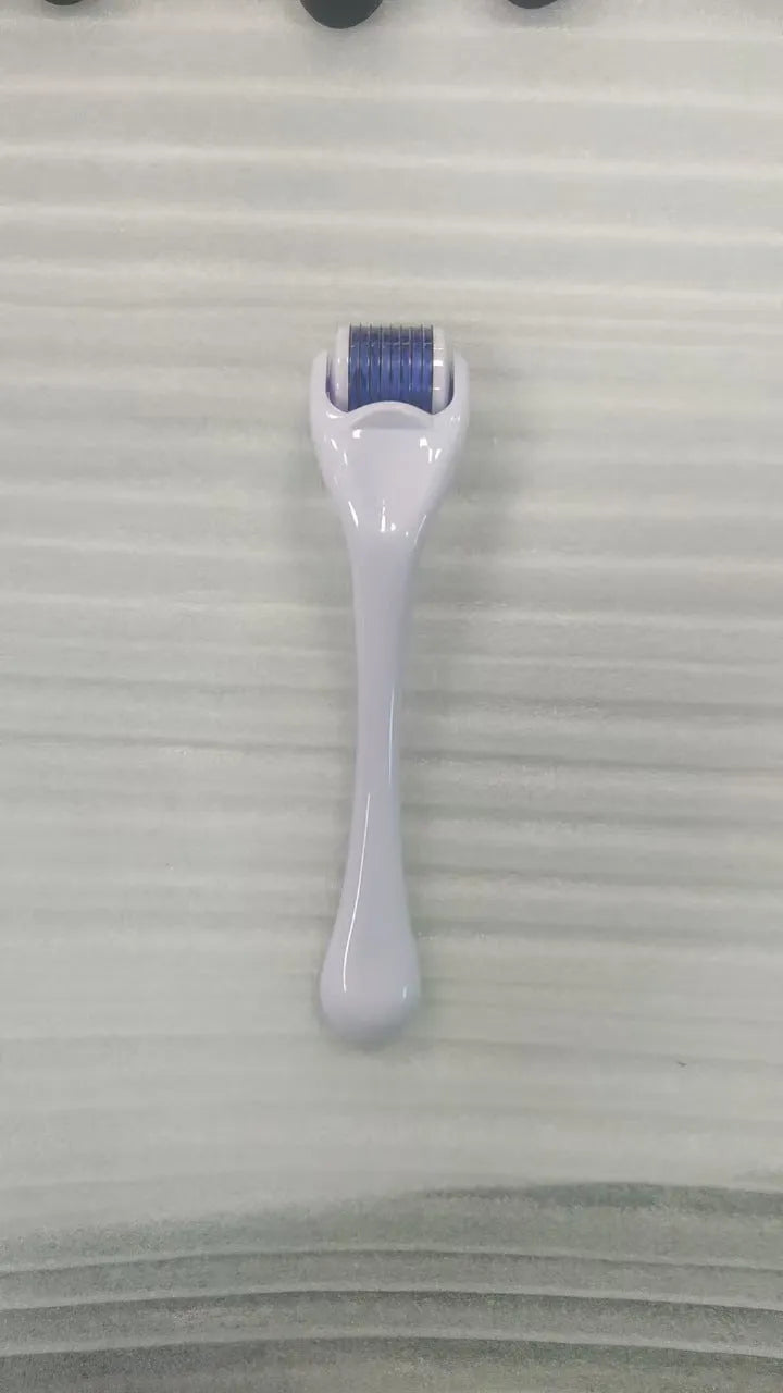 Sterile 540 micro needle derma roller showing handle and needle wheel in assorted colours.