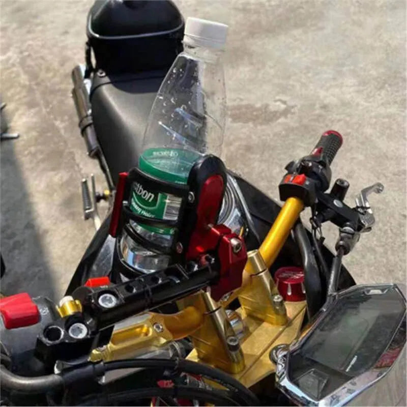 Modified black water bottle cage mounted on a Honda X-ADV scooter bumper