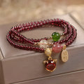 Purplish red garnet fox crystal bracelet with adjustable rope closure