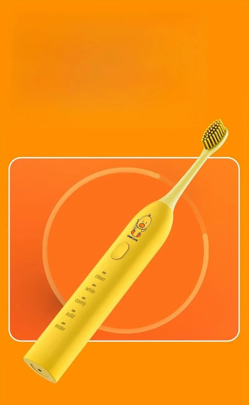 Yellow rechargeable electric toothbrush with soft bristles on a bathroom counter