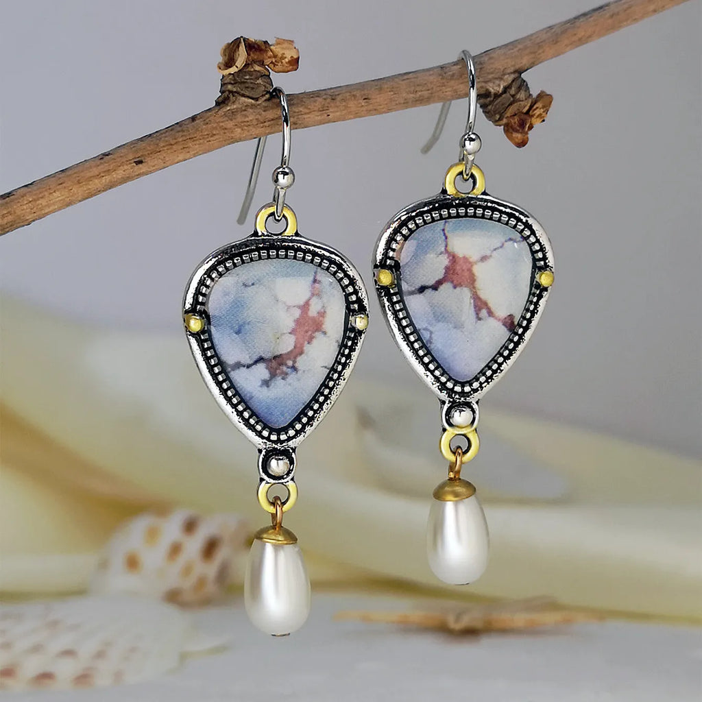 Retro blue drop earrings with synthetic blue opal and white pearl on electroplated metal.