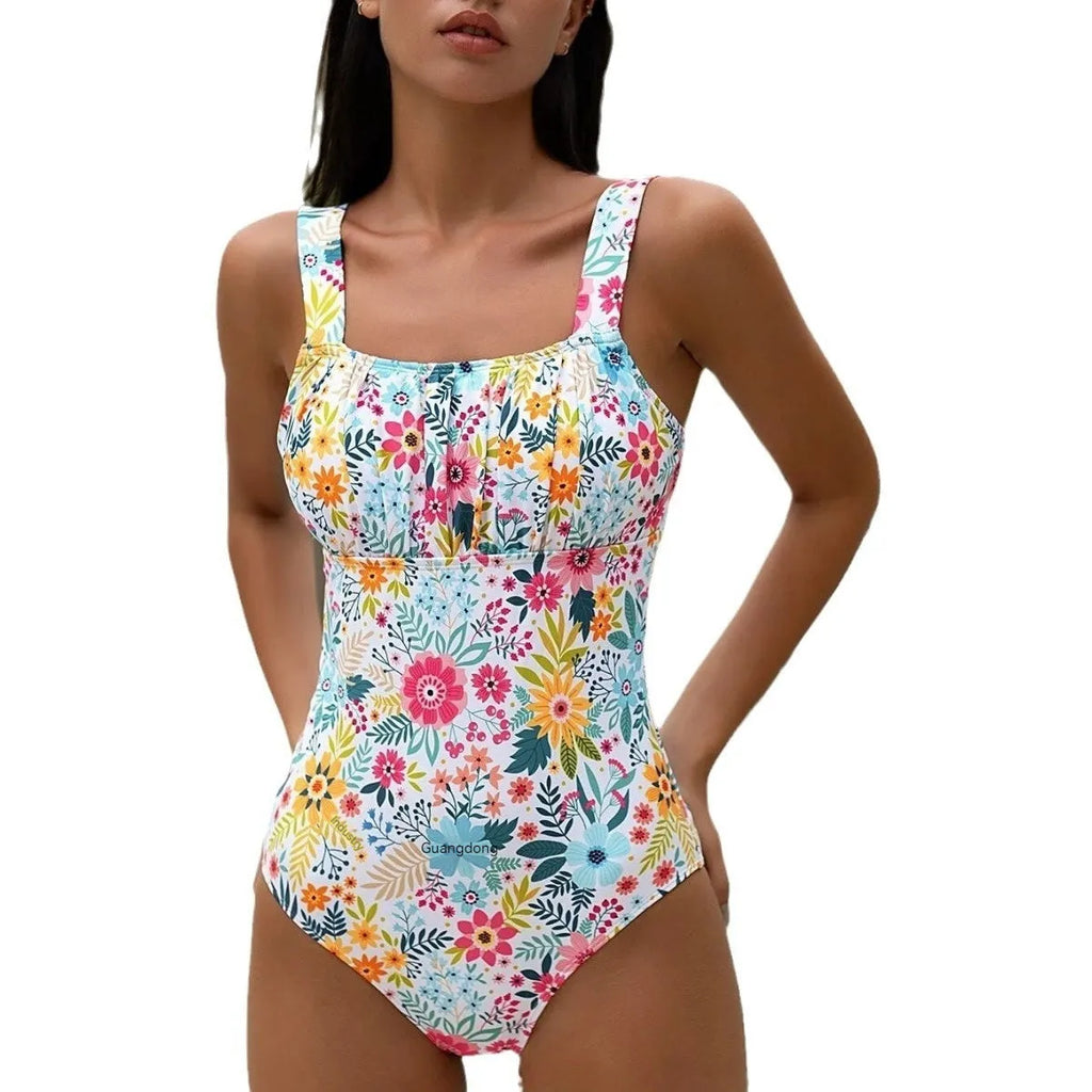 Women's pastoral style floral print one-piece swimsuit on a hanger, showing front design.
