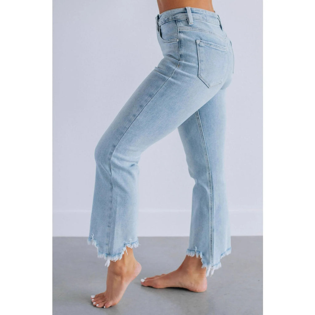 Solid colour women's cotton denim jeans with a hand-distressed finish in dark blue