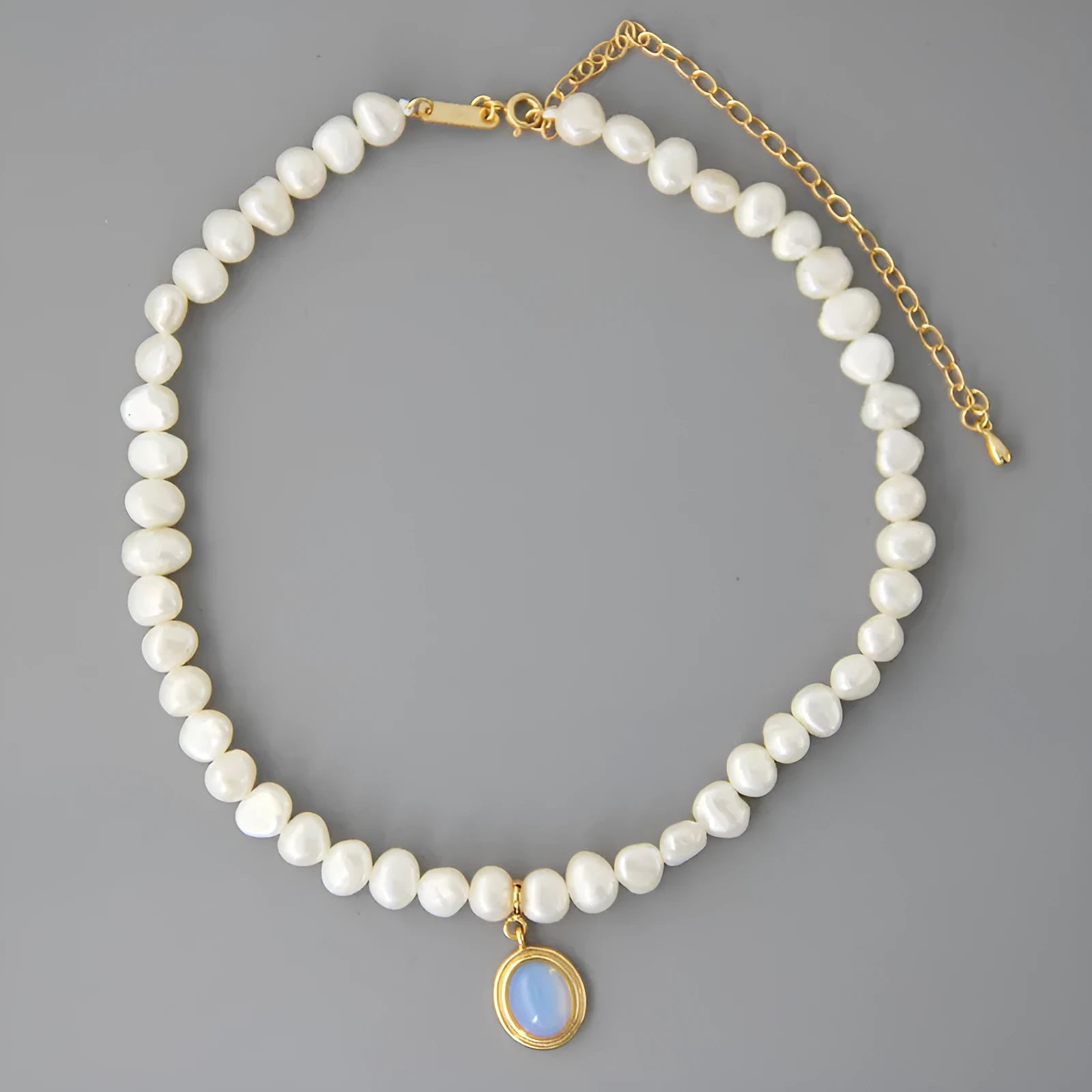 Silver geometric necklace with round medal and pearl pendant on adjustable chain
