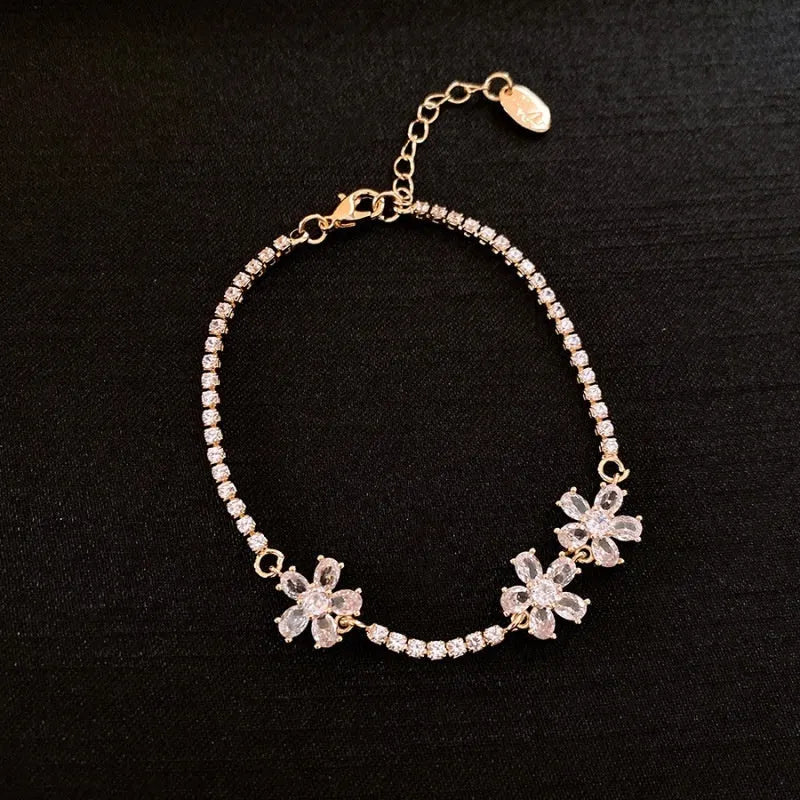 Gold tone geometric copper bracelet for women with zircon inlay detail.