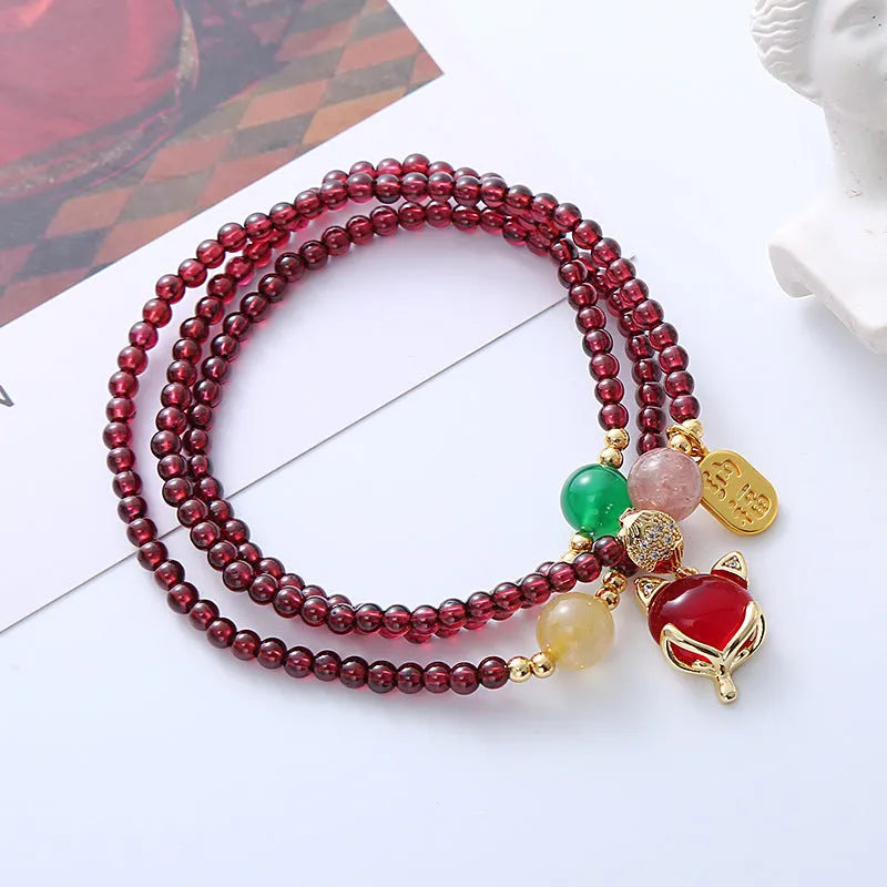 Purplish red garnet fox crystal bracelet with adjustable rope closure