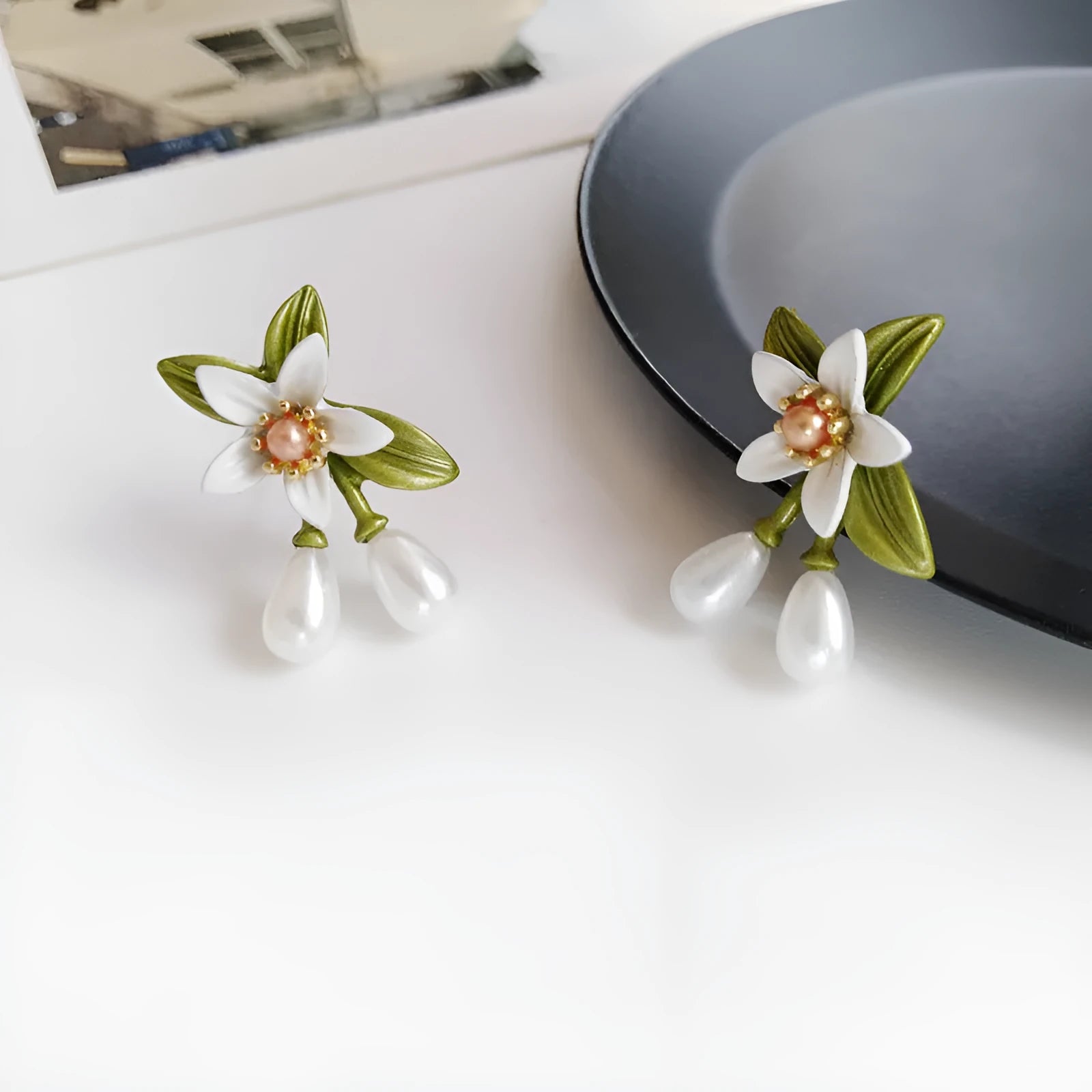 Women's alloy flower earrings showing sterling silver needle detailing on studs and contrast colours on clips
