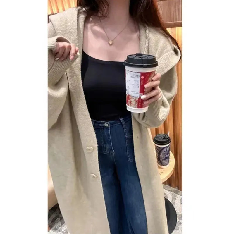 Korean style long hooded cardigan for women in oatmeal colour, showing below-the-knee length and loose fit.