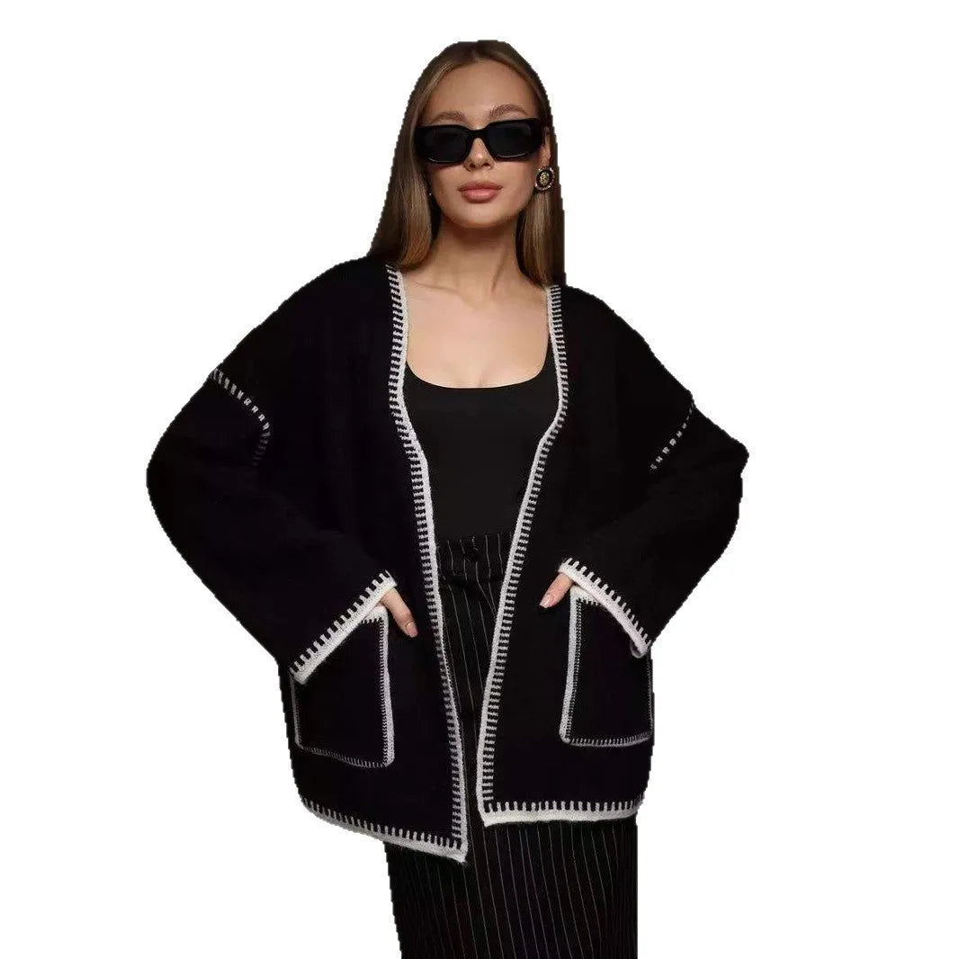 Loose fit knitted cardigan sweater in black, camel, or white colour on a hanger