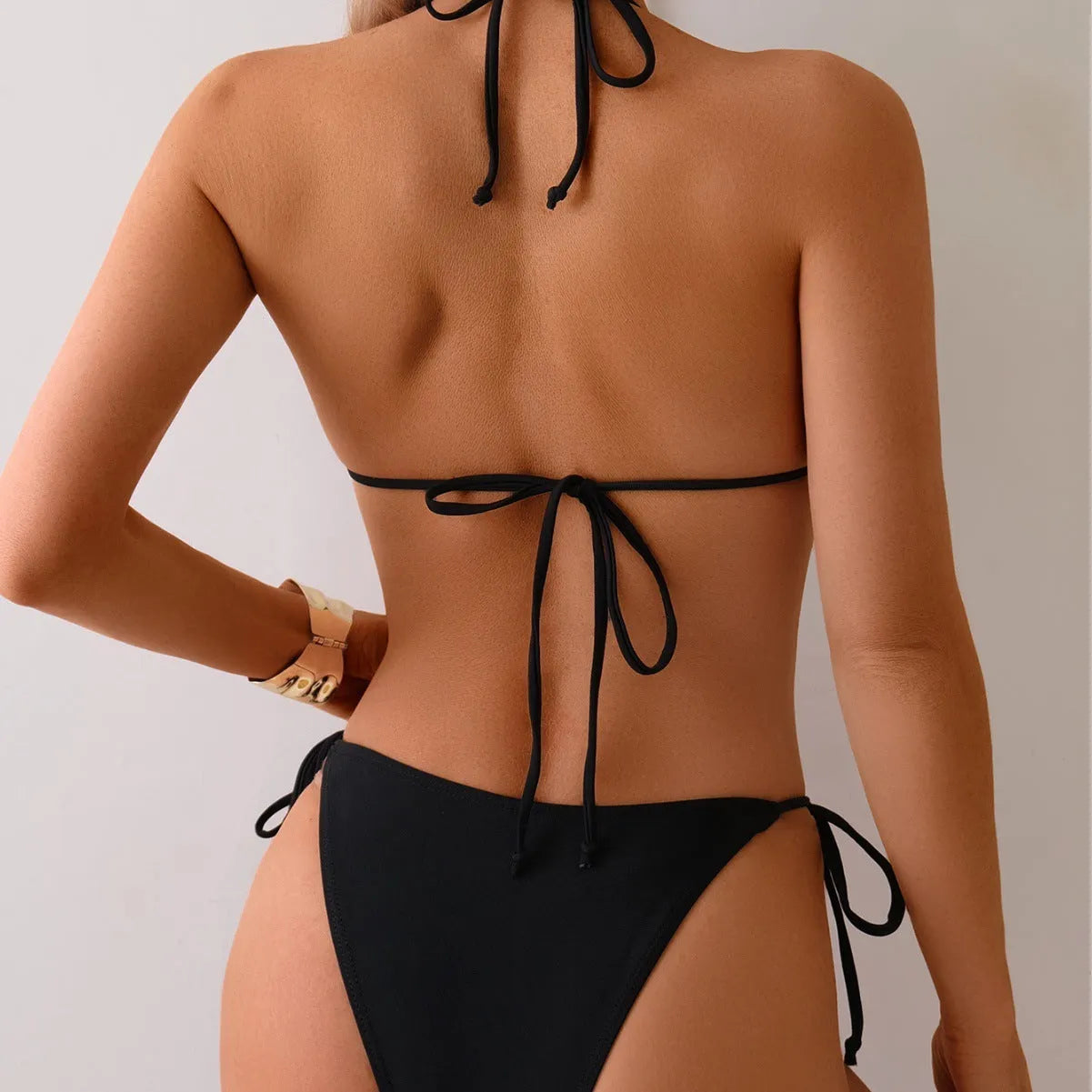 Black women's polyester bikini swimsuit with metal bead detail and split design