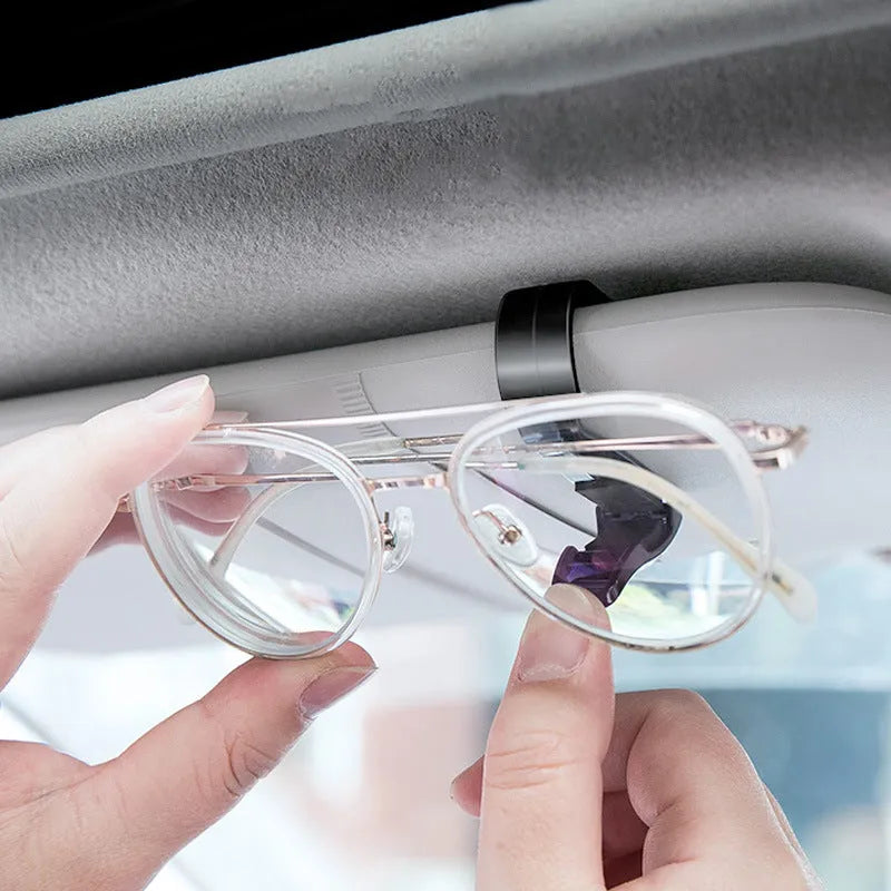 Black plastic car sun visor clip organiser for glasses, tickets and ID cards measuring 6.5 by 2.3 centimetres