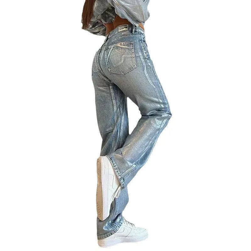 Washed blue high waist straight leg women's jeans on a neutral background.
