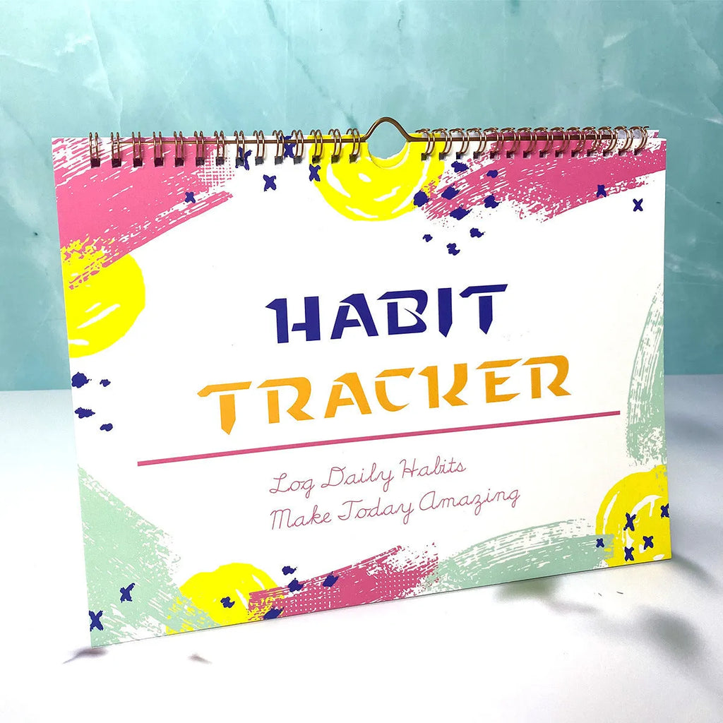 Habit tracking journal notebook open showing planning pages with colour options