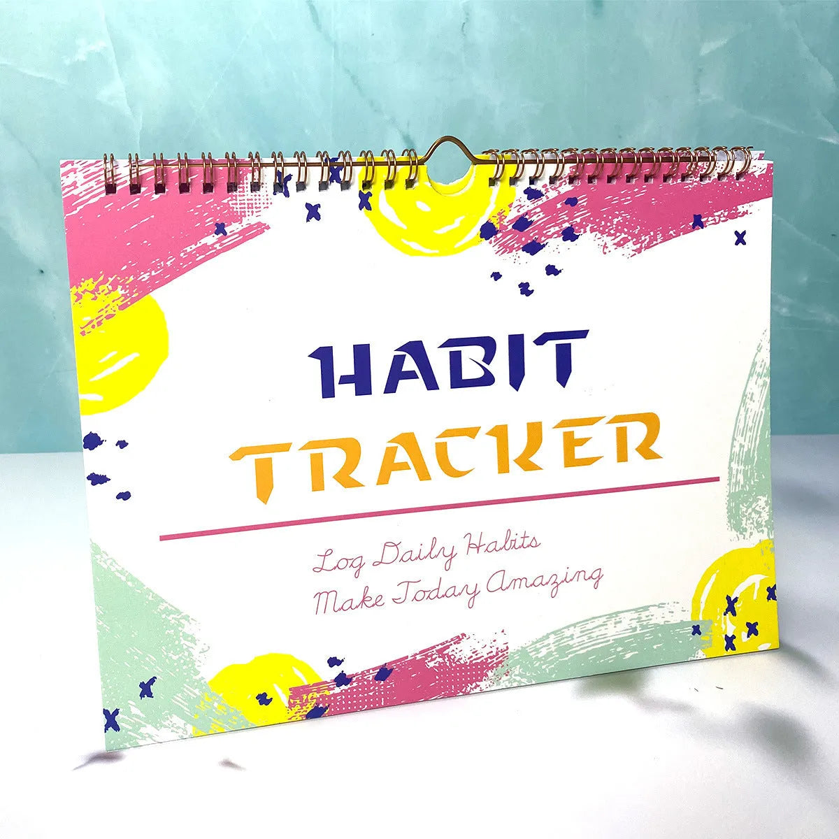 Habit tracking journal notebook open showing planning pages with colour options