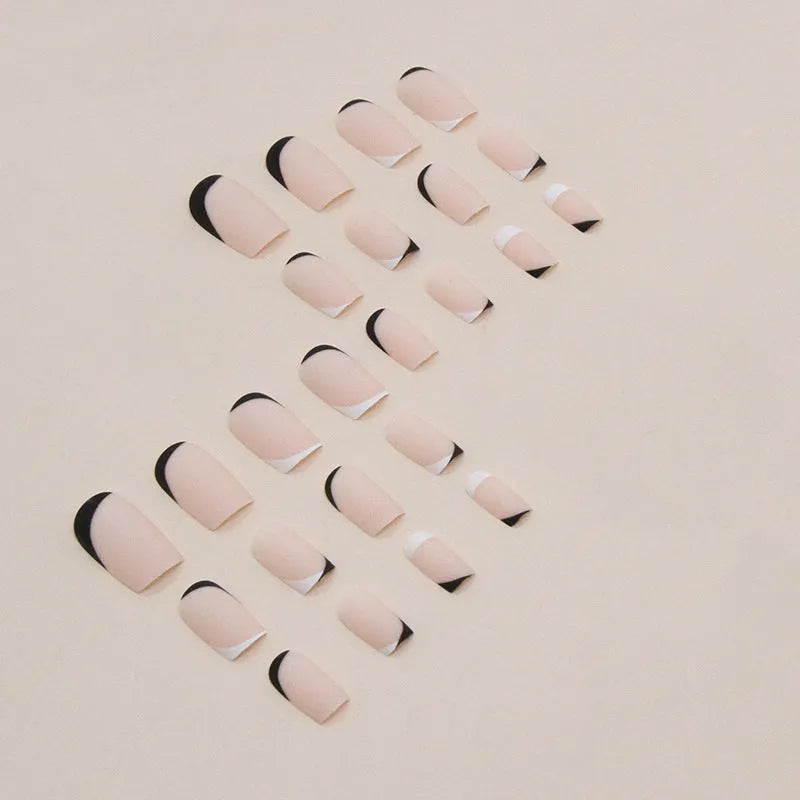 Black and white frosted matte false nails with French style design on display