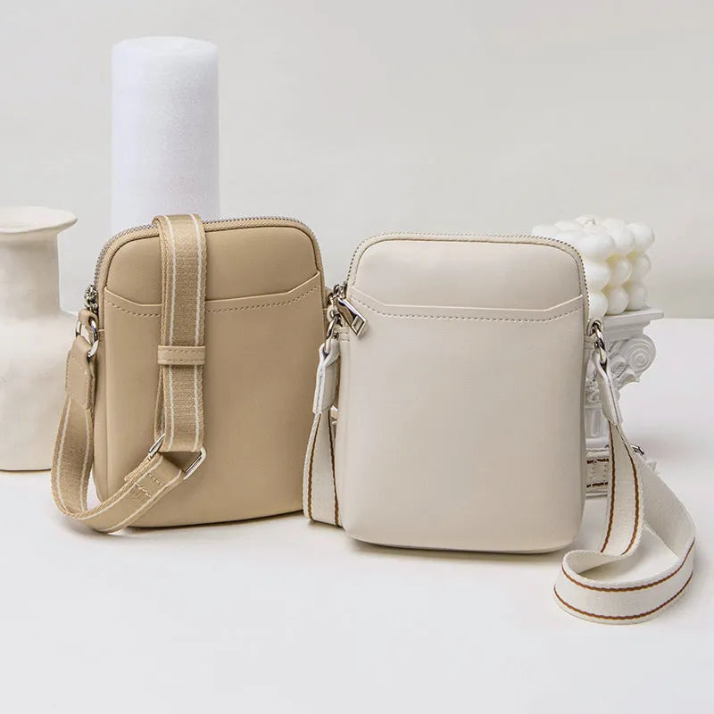 Solid colour PU leather mobile phone crossbody bag in beige showing shoulder strap and compact size
