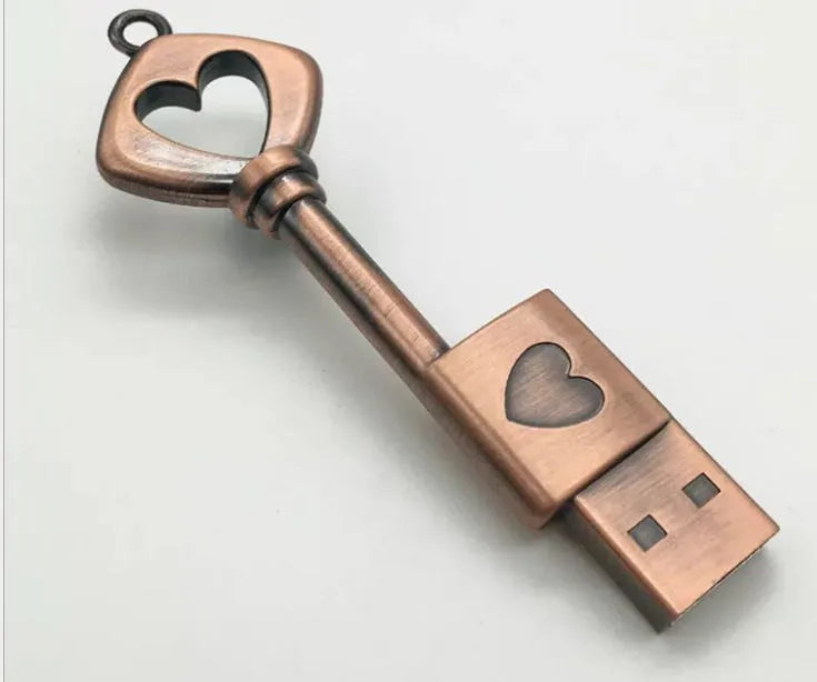 Heart shaped bronze metal USB flash drive pendant with USB 2.0 interface and write protection switch.