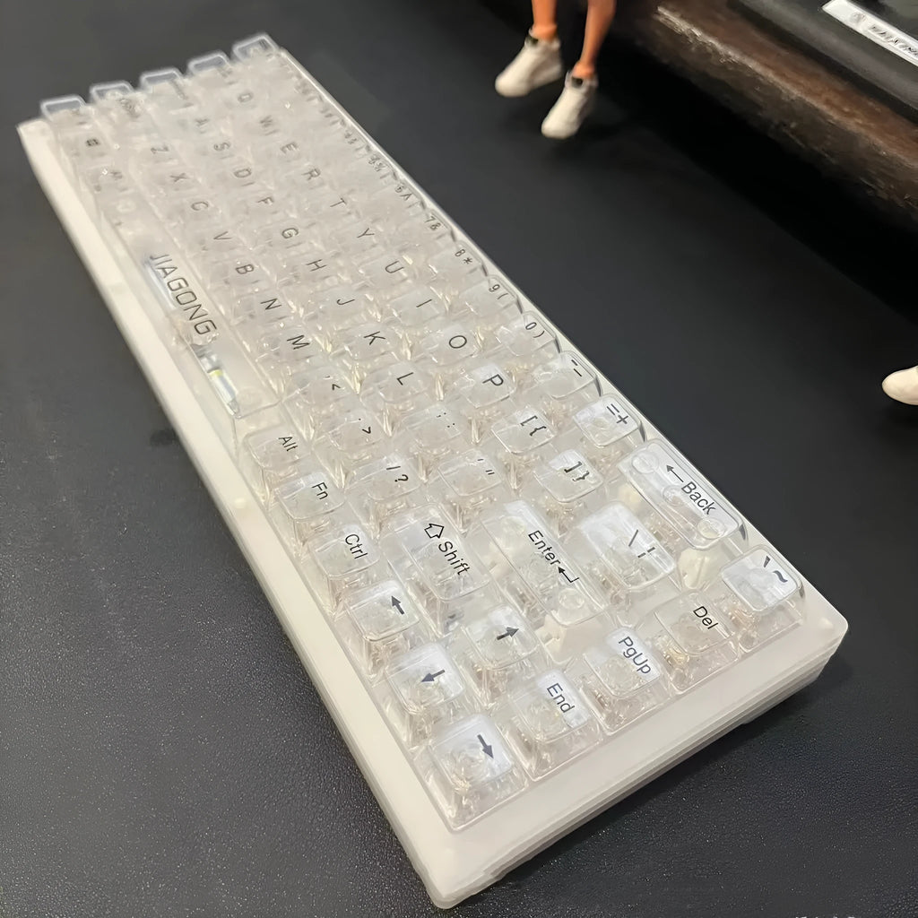 Transparent plastic mechanical keyboard key cap set with 132 pieces arranged for full keyboard coverage
