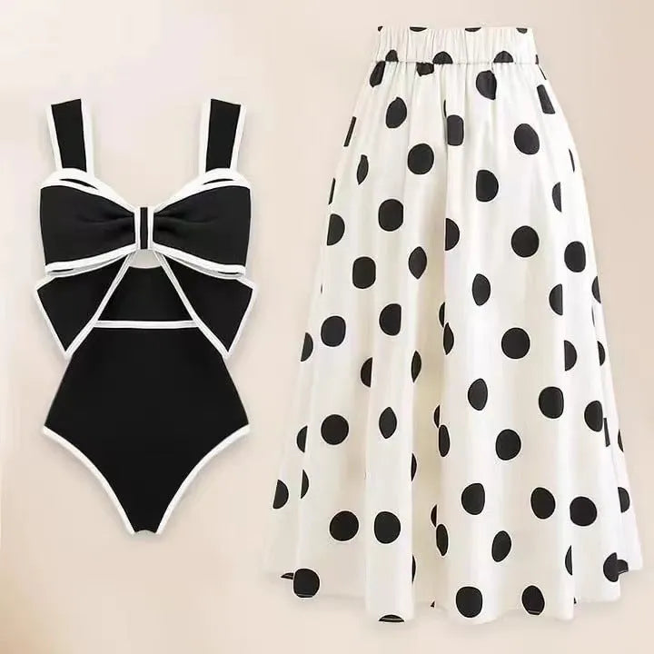 Women's black one-piece swimsuit with white round skirt and bow detail for swimming