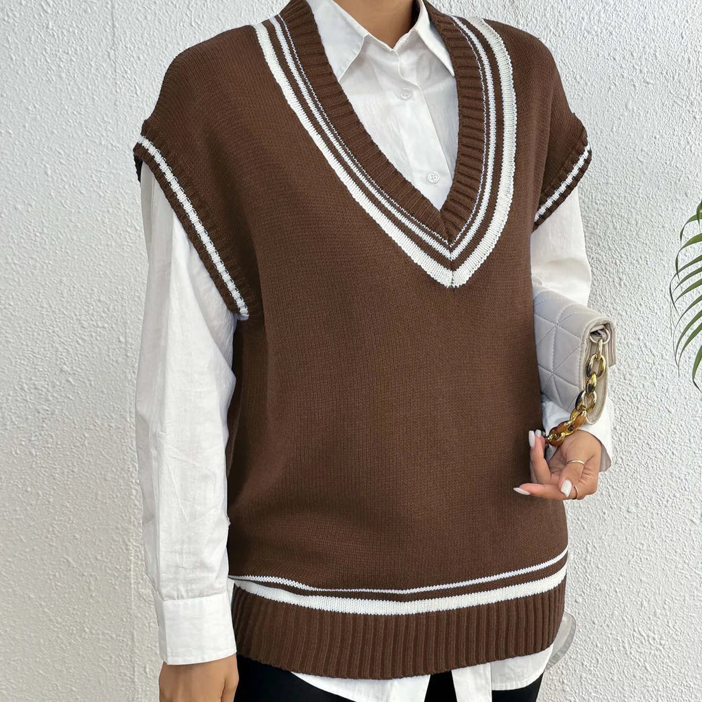 Loose fit blue women's vest sweater in college style, shown as a pullover on a hanger.